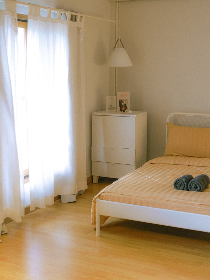 Bright minimalist bedroom interior with natural lighting in Bangkok, Thailand.